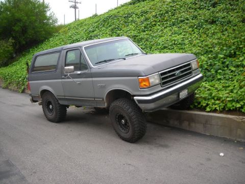 1988 Ford Bronco - This 1988 Ford Bronco is parked with its front wheels on a concrete curb.