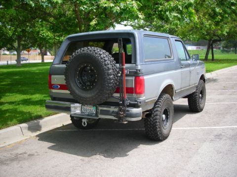 1988 Ford Bronco - This 1988 Ford Bronco features a two-tone paint scheme and a spare tire mounted externally on the rear.