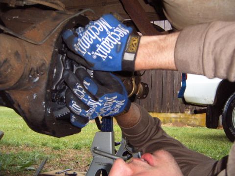 1988 Ford Bronco - Working on the rear differential assembly of a vehicle.