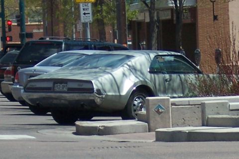 1972 Ford Ranchero - Rear view of a 1970 Oldsmobile Toronado parked on a city street.