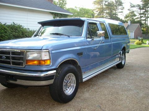 1995 Ford Bronco - This blue 1995 Ford Bronco is equipped with a camper shell and seen from a 3q-front angle.