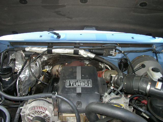 Engine bay of a 1995 Ford Bronco, showing the diesel turbo engine with "DIRECT INJECTION TURBO" labeling