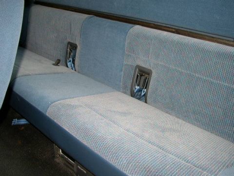 1995 Ford Bronco - The rear bench seat features blue fabric with a subtle pattern and integrated seatbelts.