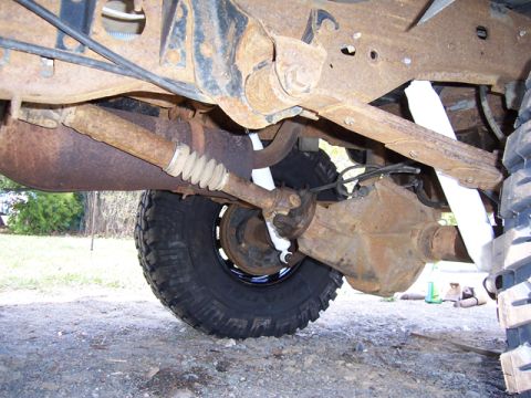 1996 Ford Bronco - The rear axle, driveshaft, and suspension components of a heavily modified truck are visible in this undercarriage shot.