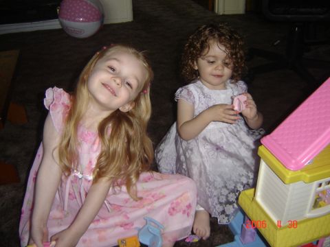 1993 Ford Bronco - Two girls in dresses play with toys on the floor. A pink and white ball is visible in the background.