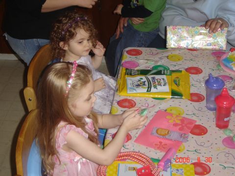 1993 Ford Bronco - Children gather around a table adorned with a colorful tablecloth, engaging in activities at what appears to be a birthday celebration.