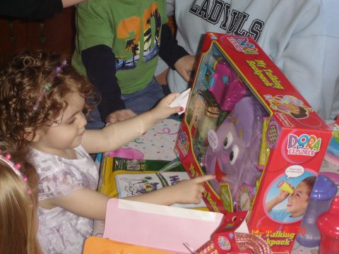 1993 Ford Bronco - A group of children are excited to open a Dora the Explorer toy at a party.