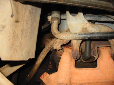 1988 Ford Bronco - passenger side crossover tube bolt in the center and left side of the transmission dipstick tube.