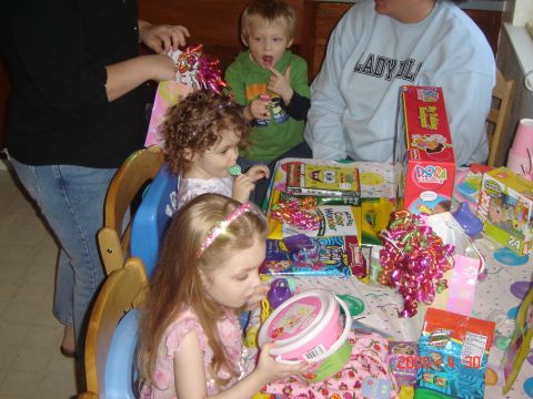 1993 Ford Bronco - A birthday party scene with children opening presents and playing with toys.