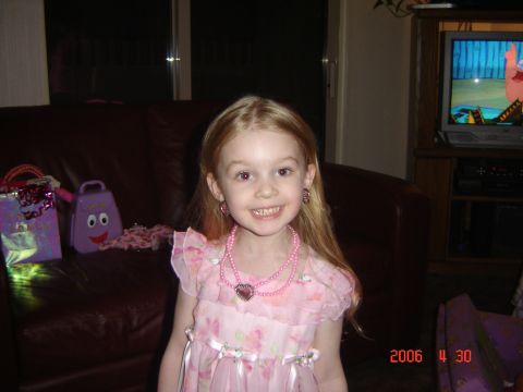 1993 Ford Bronco - A young girl in a pink dress smiles for the camera, with toys and gift bags visible on a couch.