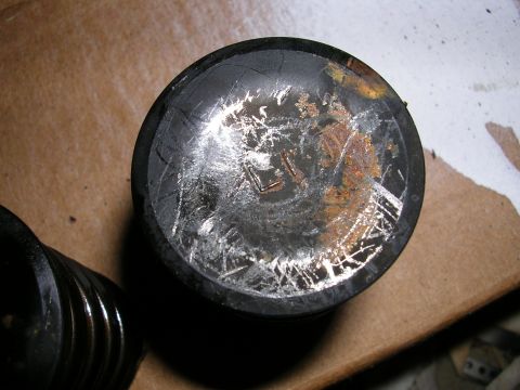 1996 Ford Probe - A worn piston shows significant scoring and rust damage, indicating potential engine issues.