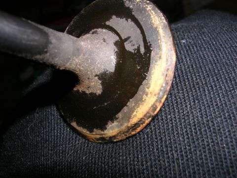 1996 Ford Probe - Close-up of an engine valve showing oil accumulation on the head and stem.
