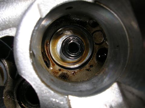 1996 Ford Probe - A detailed view of an internal engine part, showing signs of wear and oil residue.