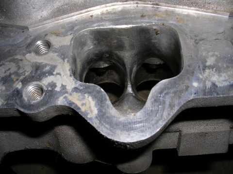 1996 Ford Probe - Close-up view of the intake ports on an engine cylinder head, showing the dual openings and mounting holes.