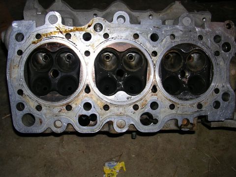 1996 Ford Probe - Close-up of an engine cylinder head, revealing the combustion chambers and valve seats.