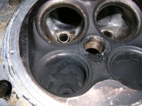 1996 Ford Probe - Close-up of an engine cylinder head, revealing the condition of its combustion chambers and valve seats.