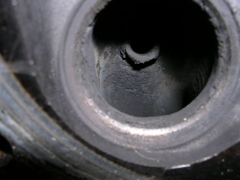 1996 Ford Probe - This image shows a close-up view of a heavily carbonized engine cylinder head, likely from a vehicle's internal combustion engine.