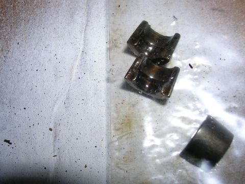 1996 Ford Probe - Close-up of three valve keepers, likely from an engine. The parts are metallic and appear used.