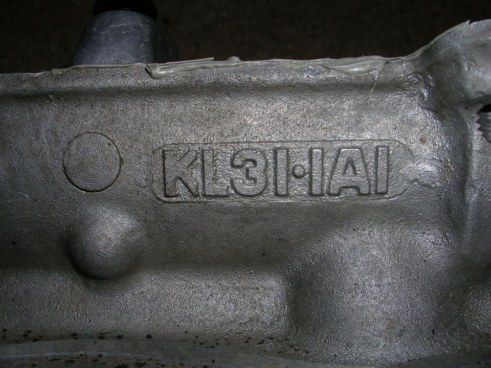Engine part with raised casting numbers KL31-1A. Casting appears to be aluminum