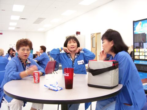 1994 Ford Probe - Three women are seated around a table in what appears to be a break room or cafeteria.