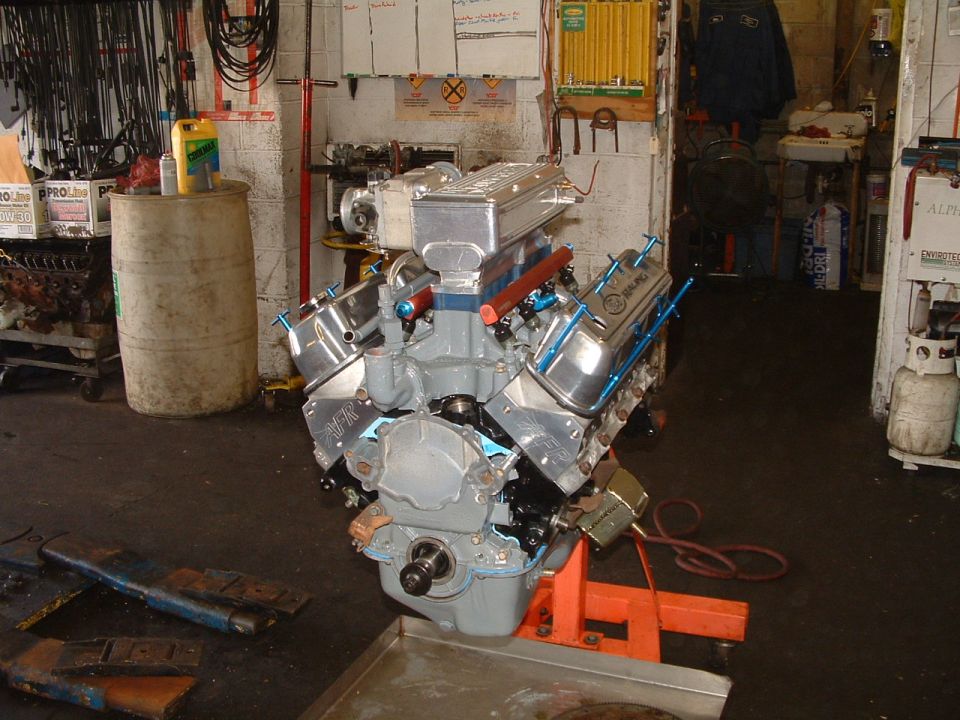 Engine on an orange stand in a garage