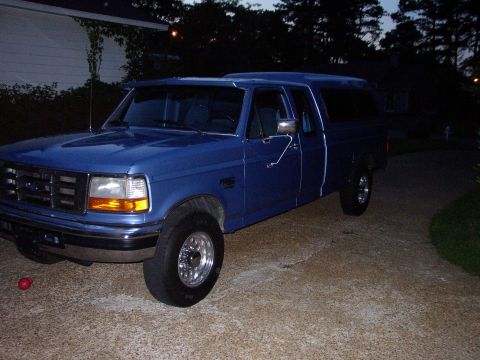 1995 Ford Bronco - This blue 1995 Ford Bronco is equipped with a camper shell and seen from a 3q front angle.
