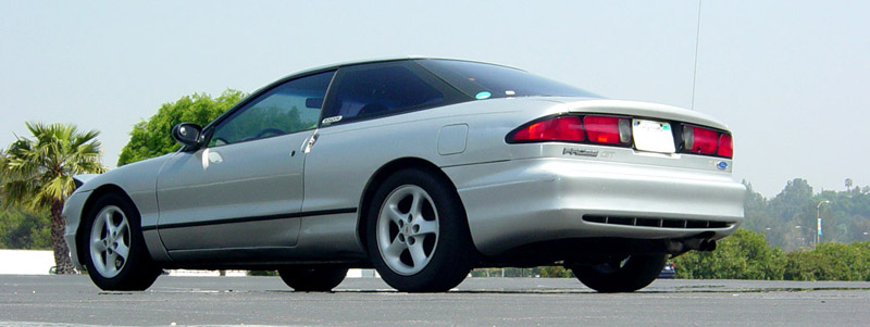 Silver Ford Probe coupe rear three-quarter view on alloy wheels, palms behind