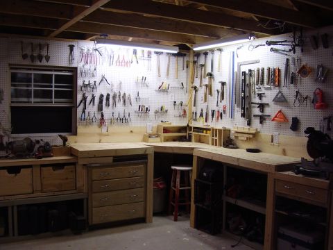1990 Ford Bronco - A well-organized workshop features ample storage and tool organization on pegboard walls.