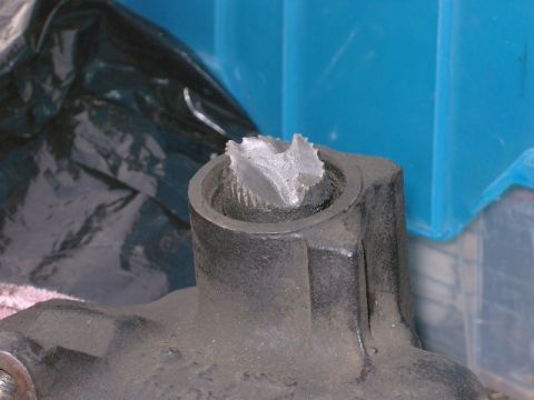 1996 Ford Bronco - A close-up view of a heavily damaged metal component, showing signs of significant wear and tear.