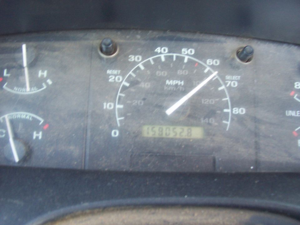 Dashboard gauges showing speed, fuel, and temperature. Odometer reads 158052.8