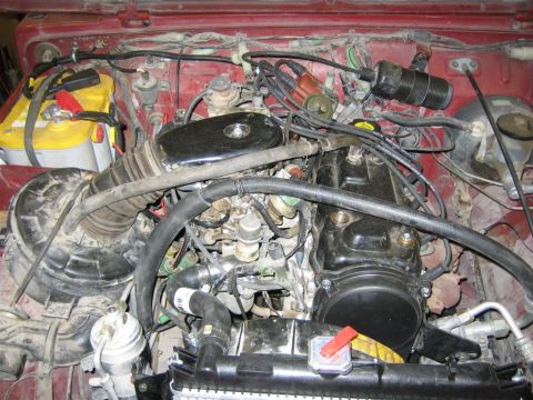 1987 Suzuki Samurai - Close-up view of a vehicle's engine bay, showing various components and wiring.