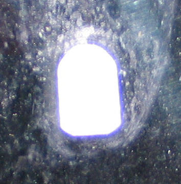 1994 Ford Bronco - A close-up view of a car mirror with a bright light source.