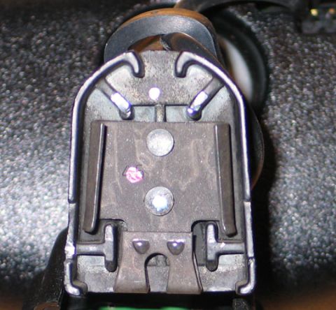 1994 Ford Bronco - This is a close-up view of a seatbelt retractor mechanism, showing its internal components.