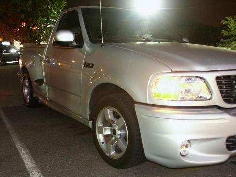 2001 Mercury Grand Marquis - This silver pickup truck, identified by its 'Lightning' badging, is shown from a 3q-front angle.