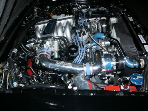 2001 Mercury Grand Marquis - Close-up of a modified engine bay a supercharger and custom intake piping.