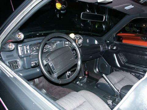 2001 Mercury Grand Marquis - The interior of a car shows aftermarket gauges and a manual transmission shifter.