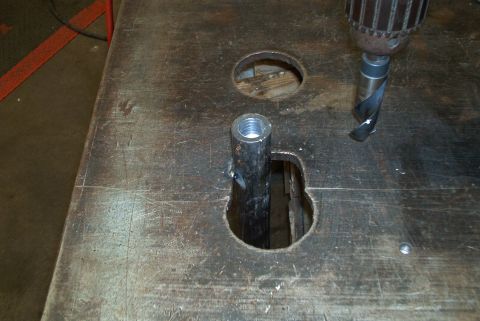 1983 Ford Bronco - A metal pipe is being worked on with a drill bit on a damaged metal surface.