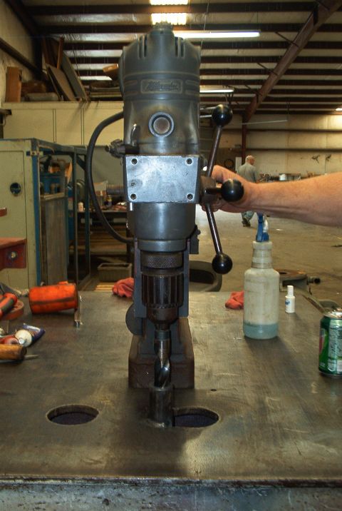 1983 Ford Bronco - A drill press is shown in a workshop setting with various tools and supplies nearby.