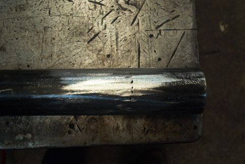 1983 Ford Bronco - Metal pipe with scribe marks, likely for cutting or modification.