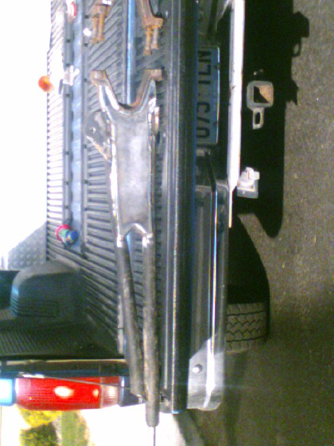 1989 Ford Bronco - Close-up of the rear axle and suspension of a Ford Bronco, with a license plate in view.