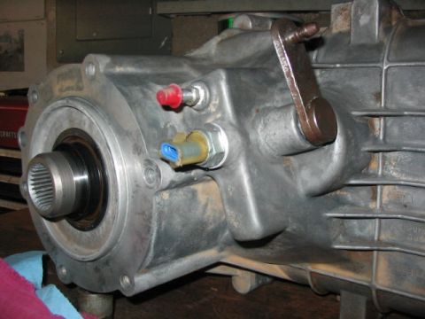 1995 Ford Bronco - Transfer case assembly showing the output shaft and sensor connections.