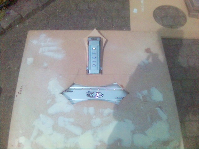 Silver car emblem with 'Vibe' logo and 'DIETZ' text on a board