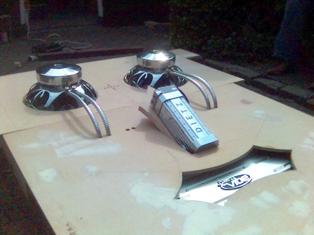 Car parts including two chrome hubcaps and a DIETZ box