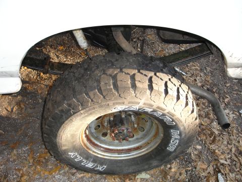 1989 Ford Bronco - The rear wheel and suspension components of a vehicle are visible in this close-up shot.