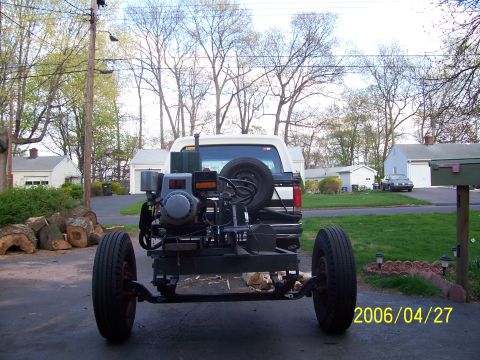 1990 Ford Bronco - Trailer with engine and spare tire attached to the rear of a 1990 Ford Bronco.