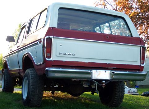 1979 Ford F-250 - This two-tone red and white Ford Bronco from 1978 is shown from the rear, prominent tires and a classic tailgate.