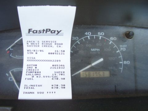 1994 Ford F-150 - Interior view of a vehicle's dashboard a speedometer and a FastPay receipt from Jack's Service.