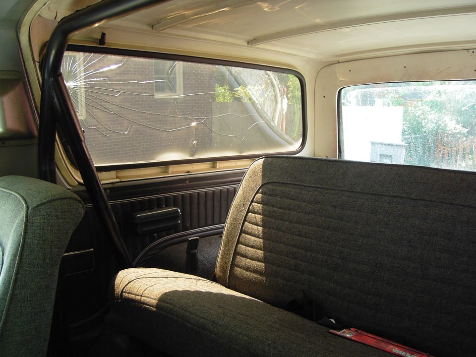 1978 Ford Bronco interior showing cracked rear window and rear seat