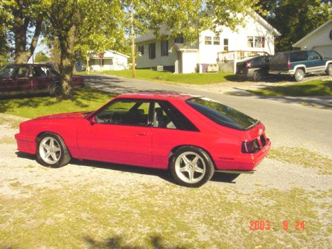 1994 Ford Probe - This red coupe features a distinctive hatchback design and a 3/4 front view. The image includes a date stamp from 2003.