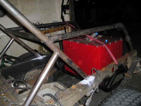 2002 Ford F-150 - This image shows the chassis of a custom off-road vehicle, a prominent red fuel tank and extensive roll cage construction.